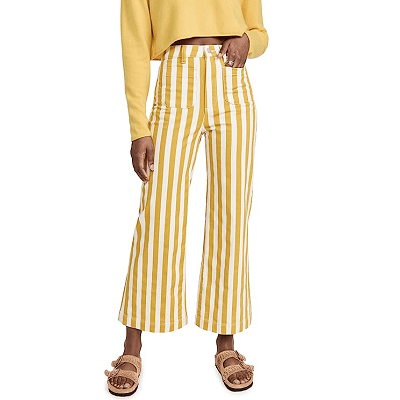 woman of color wears yellow and white striped cropped sailor jeans and matching cropped sweater