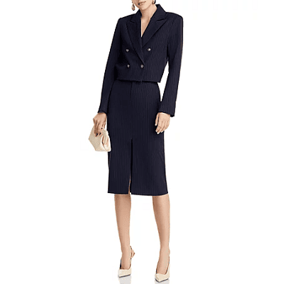 navy pinstriped suit; pencil skirt has tall slit and cropped blazer is double-breasted with gold buttons