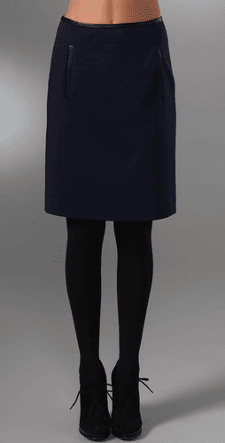 navy skirt with black tights and black strappy shoes