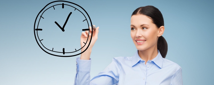 woman draws a clock on a clear pane in front of her; she is wearing a crisp blue blouse buttoned to her neck and black bottoms