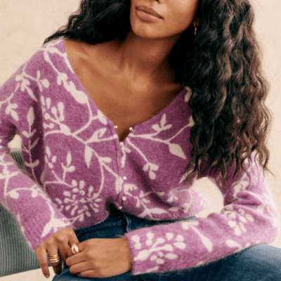 A woman wearing a purple floral cardigan