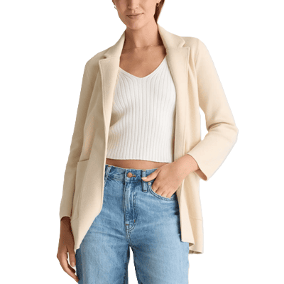 stylish professional woman wears alabaster organic knit sweater blazer with cropped white sweater and light blue denim