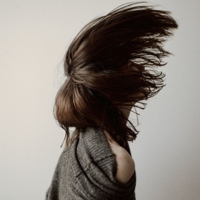 woman flips her hair forward