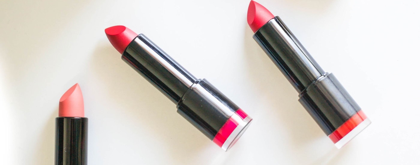 three lipsticks splayed on a white table