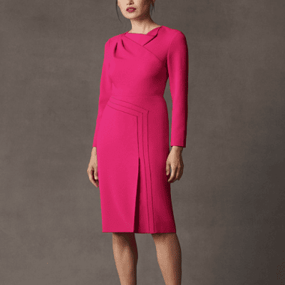 A woman wearing a pink long sleeve dress