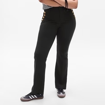 A woman wearing black pants and sneakers