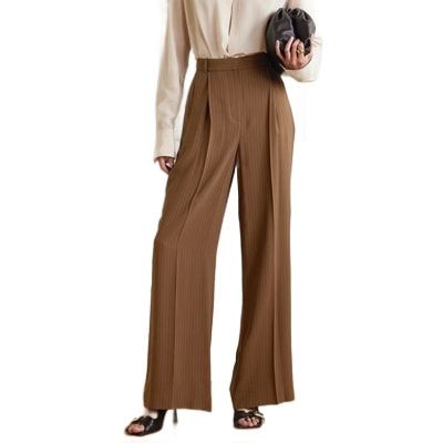 A woman wearing an off-white blouse and brown pinstripe pants