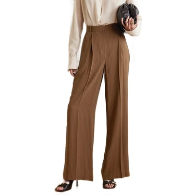 A woman wearing an off-white blouse and brown pinstripe pants 