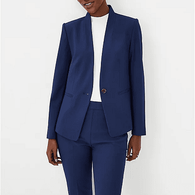 Black woman wears navy suit with white top; the blazer is a cutaway blazer