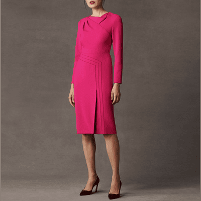 hot pink dress with folded, draped detail at the top and an asymmetric diagonal(ish) line going down the front of the skirt, ending in a front slit