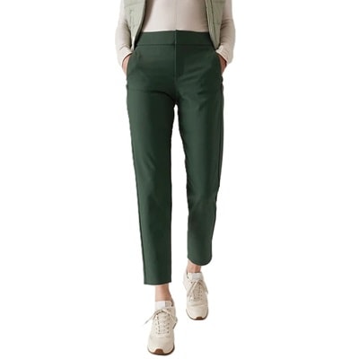 A woman wearing green pants and sneakers