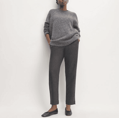 woman wears gray sweater with gray flannel pants
