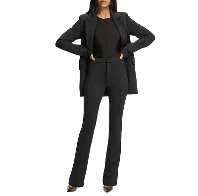 woman wears bootcut pants with black blazer; she has her hands on her hips