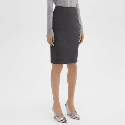 one of the best pencil skirts for work in eco-friendly Good Wool from Theory - the model is styled wearing shades of shades with a dark gray skirt, a light gray sweater, and silver Mary Jane wedge heels