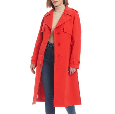 woman wears red trench coat, beige turtleneck and blue skinny jeans
