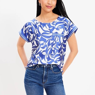 A woman wearing a blue-and-white print top and blue jeans