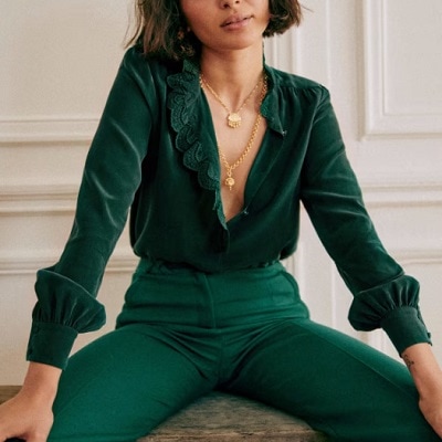 A woman wearing a green long sleeve top and green pants