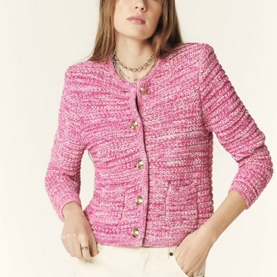 A woman wearing a pink long sleeve cardigan