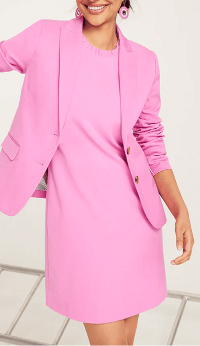 young professional woman wears pink ruffleneck dress with pink blazer
