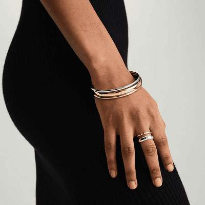 woman wears ring with mixed metals and bracelet with mixed metals