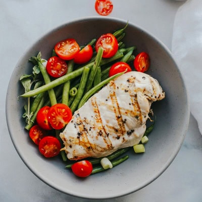 stock photo of grilled chicken, green beans and tomatoes