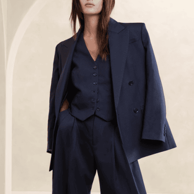 woman wears navy blazer and pants with a matching vest