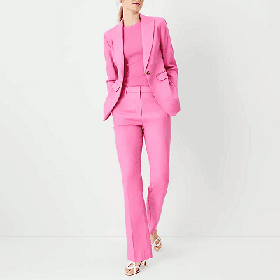professional young woman wears pink linen suit with matching pink top and (ugh) white sandals