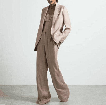 young professional woman wears slouchy pant suit in taupe
