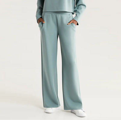 woman wears light greenish blue sweatpants with pockets