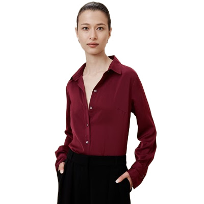 A woman wearing black pants and a wine-colored blouse