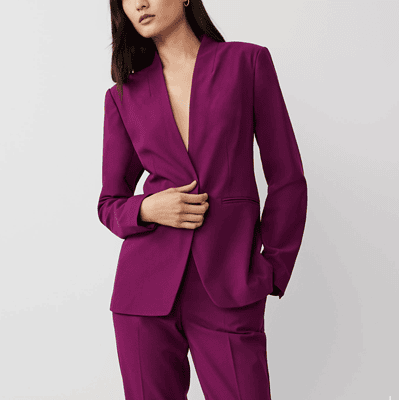 professional young woman wears a purple suit with a collarless blazer