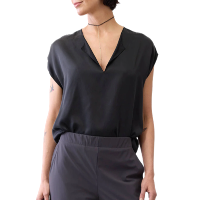 woman wears black silk blouse