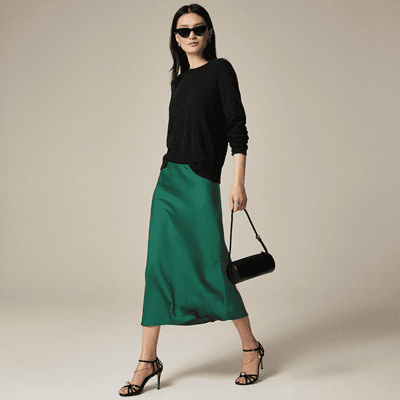 woman wears long midi slip skirt in green