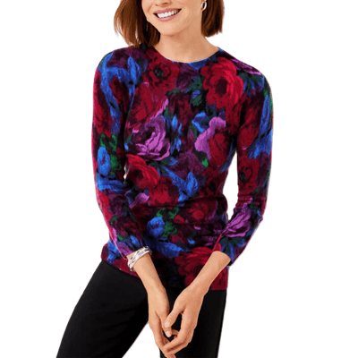 woman wears one of the best cashmere sweaters for work outfits: a cashmere boatneck sweater in a bright floral pattern