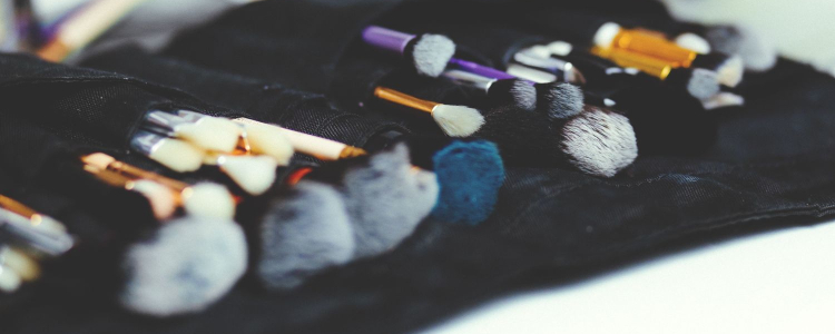 a bunch of makeup brushes and other beauty tools are laid out in a black velvet case