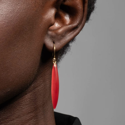 red lucite dangly earring, on a Black model