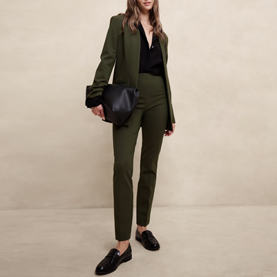 woman wears dark green suit with cropped skinny pants and collarless blazer