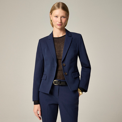 stylish professional woman wears navy shrunken blazer with navy pants