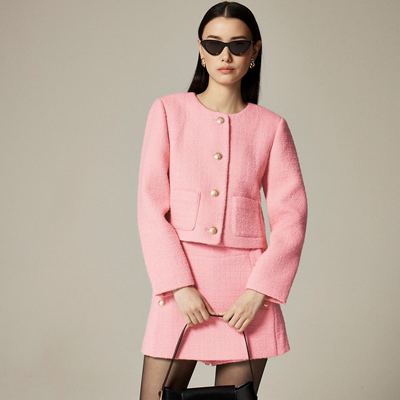 stylish young woman wears what GenZ may think is office appropriate clothing because J.Crew has it in their "wear to work" section: a baby pink tweed jacket with a very short tweed skirt