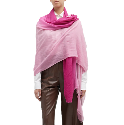 woman wears bright pink ombre scarf with brown leather pants and white button-front blouse