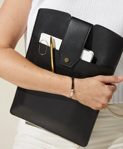 woman carries "laptop clutch" with outside pocket