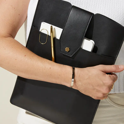 woman carries "laptop clutch" with outside pocket