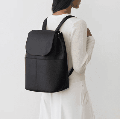 woman wears black leather backpack