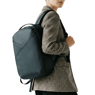 woman wears black nylon backpack with interesting fold detail
