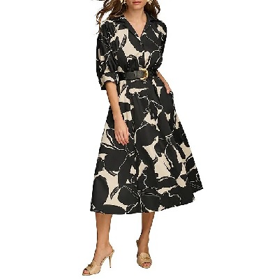 A woman wearing a cream and black floral printed midi dress and cream heels