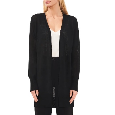 A woman wearing a white top with black long cardigan jacket and black pants