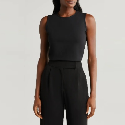 A woman wearing a black sleeveless top and a black trouser pants