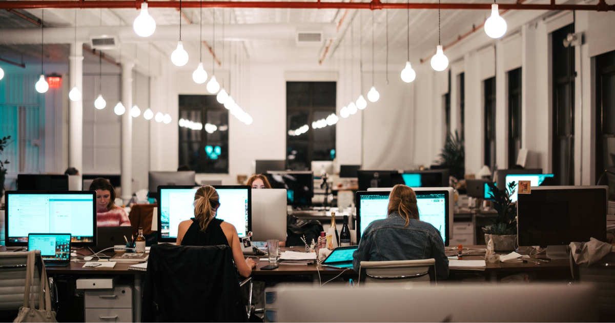 young professional women work in a business casual office after returning to the office