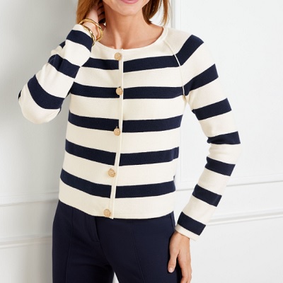 A woman wearing a white blue stripe cardigan jacket and blue pants