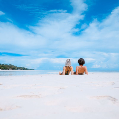 couple lazes on the beach during summer